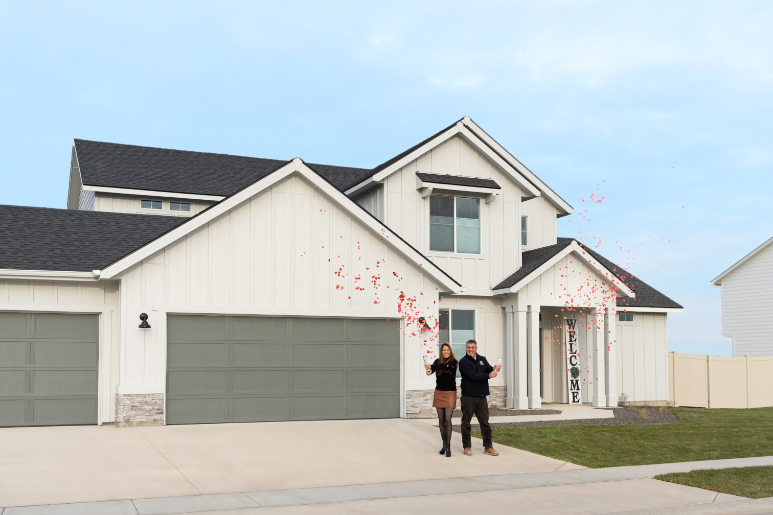 Two people standing in front of home