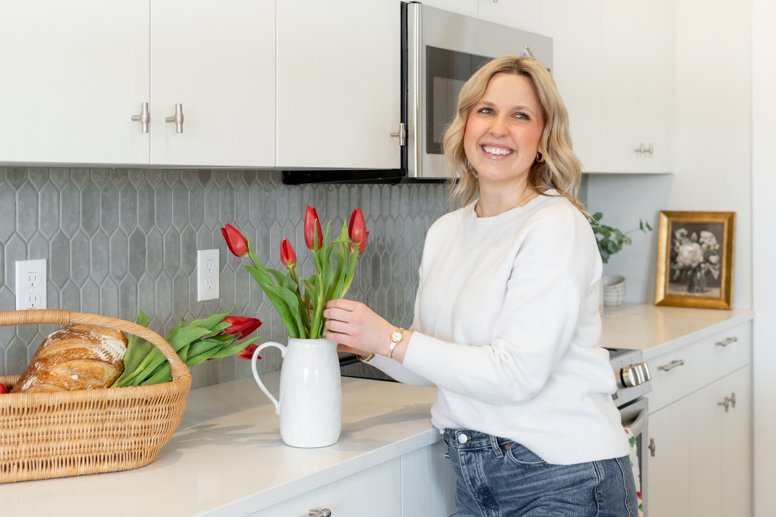 Woman arranging flowers in kitchen