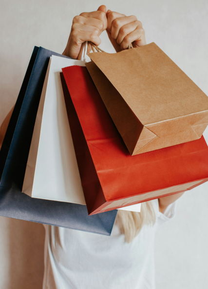 Person holding up shopping bags