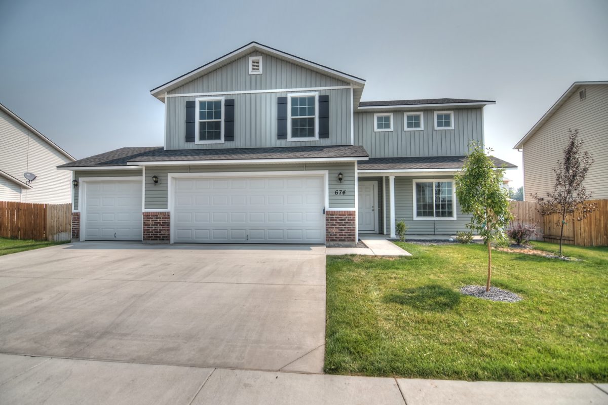 CBH Homes floor plan elevation featuring a modern home exterior with a gable roof and front garage.