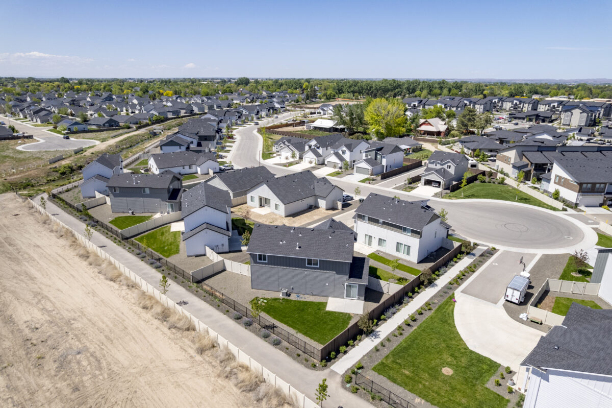 High aerial image showing a well-structured street layout with a mix of straight and curved roads, multiple cul-de-sacs, and a mix of completed and under-construction homes.