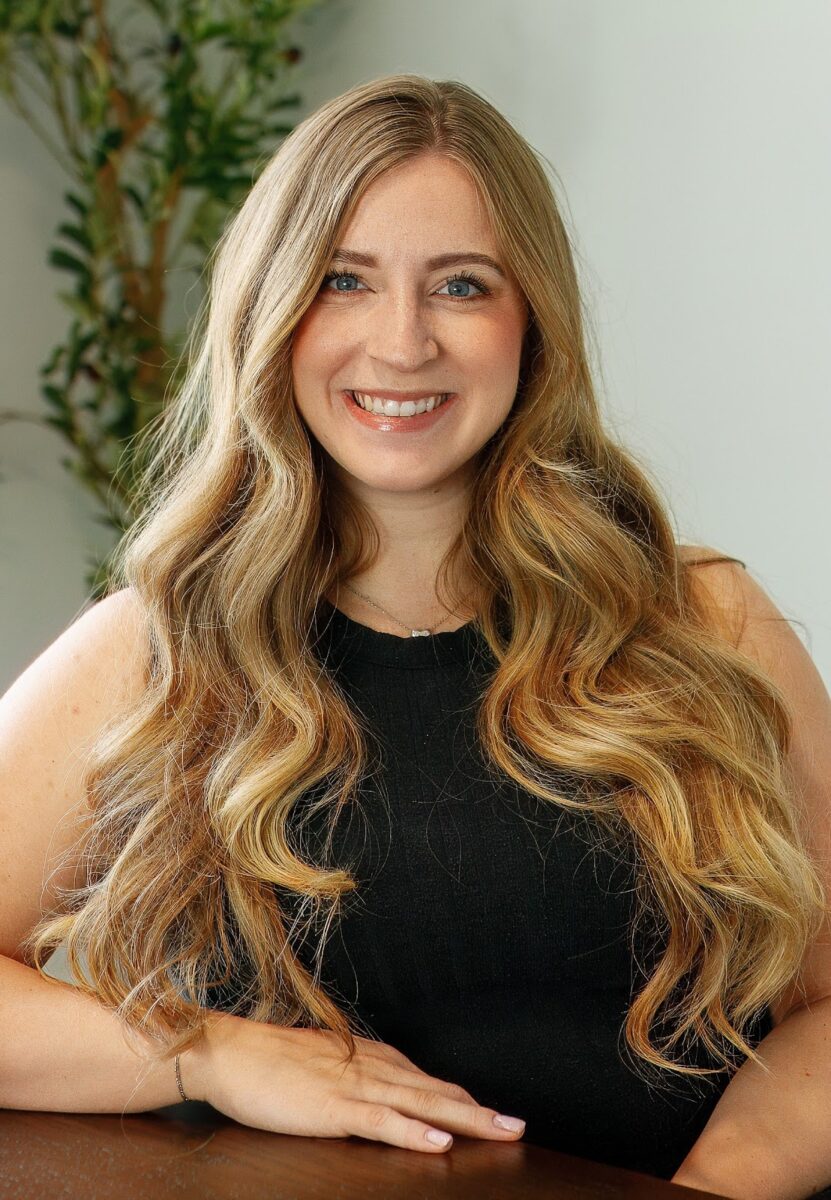 Smiling lady in black top and jeans