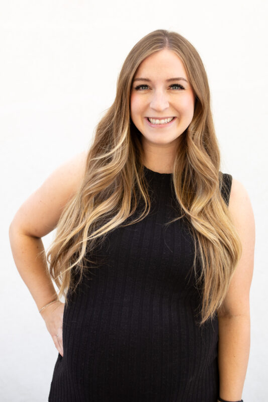 Smiling lady in black top and jeans