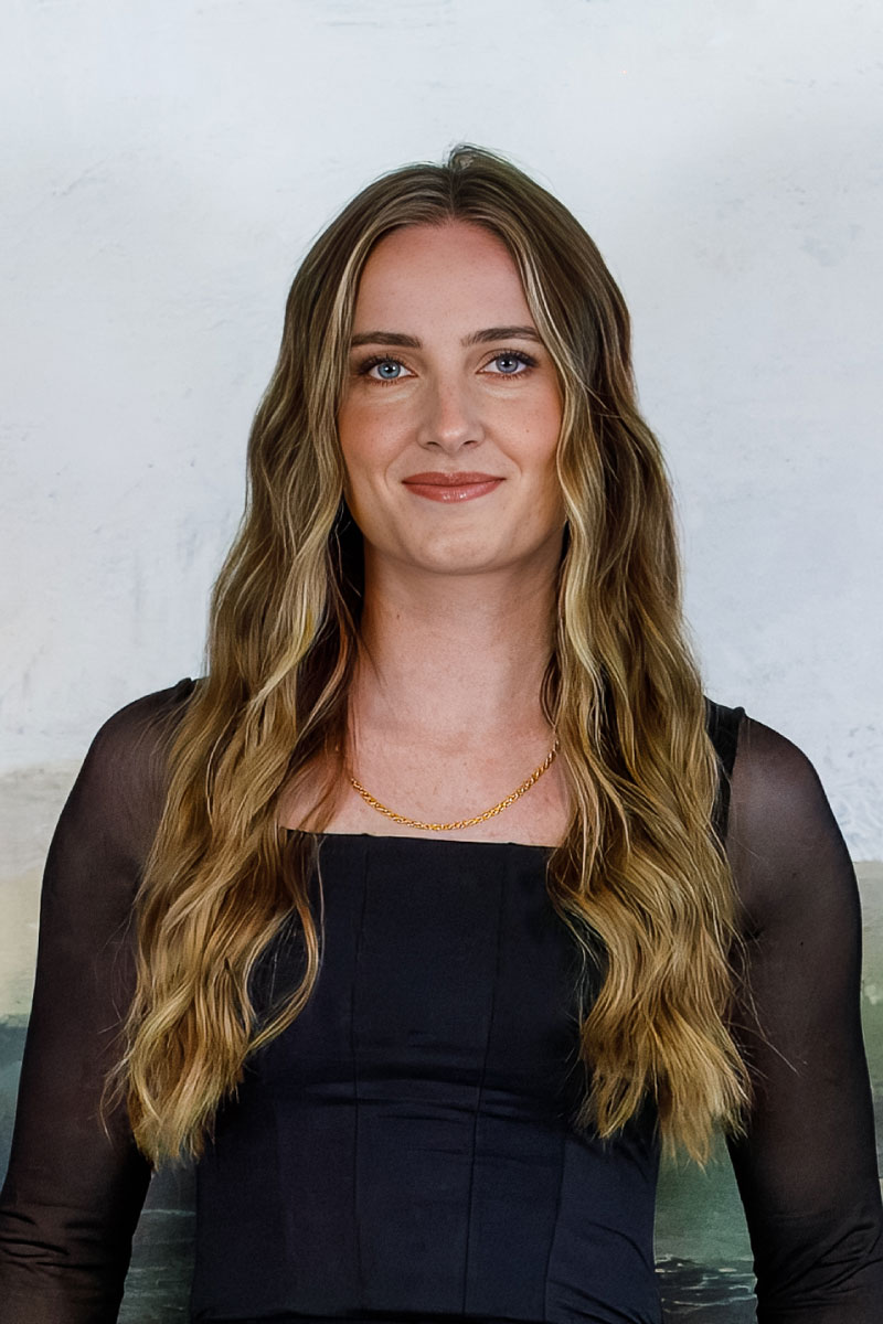 Professional headshot of Cassidy Seamons, Listing Coordinator at CBH Homes, smiling with long highlighted hair in a clean, professional setting