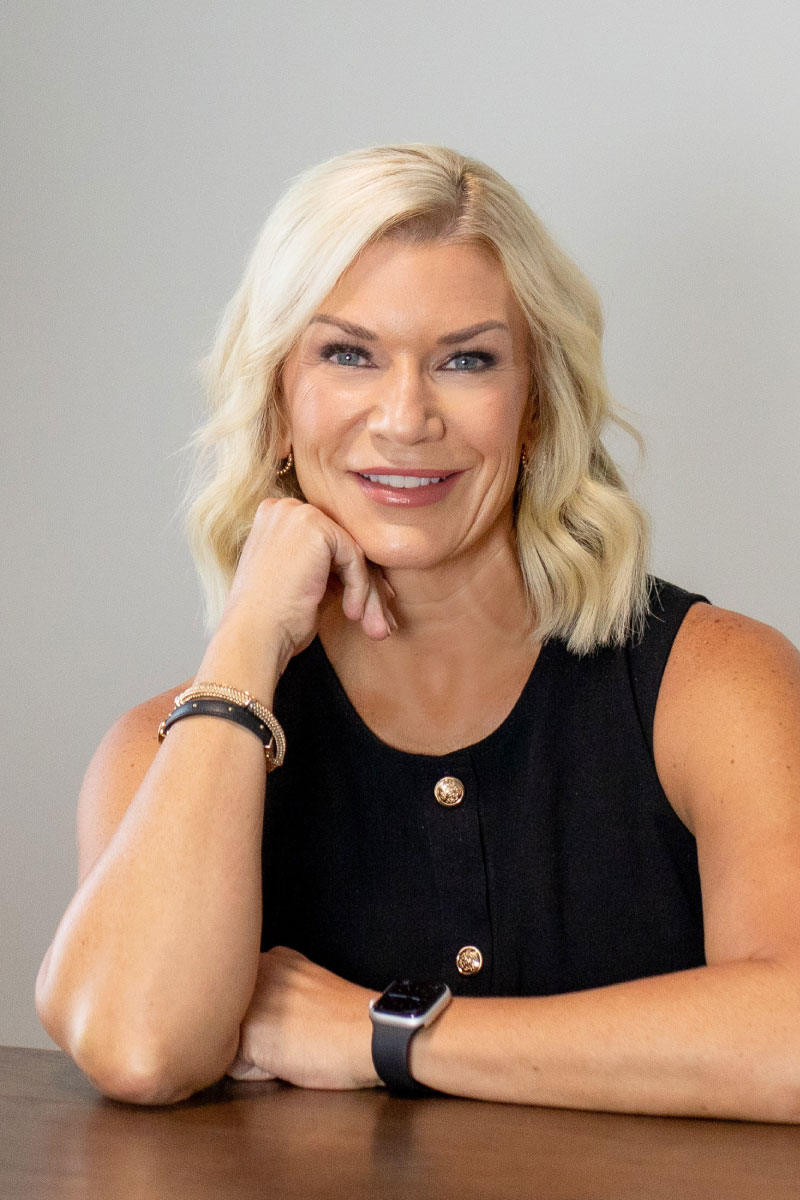 Lindsey Smith, new home advisor at CBH Homes, smiling and wearing a black shirt