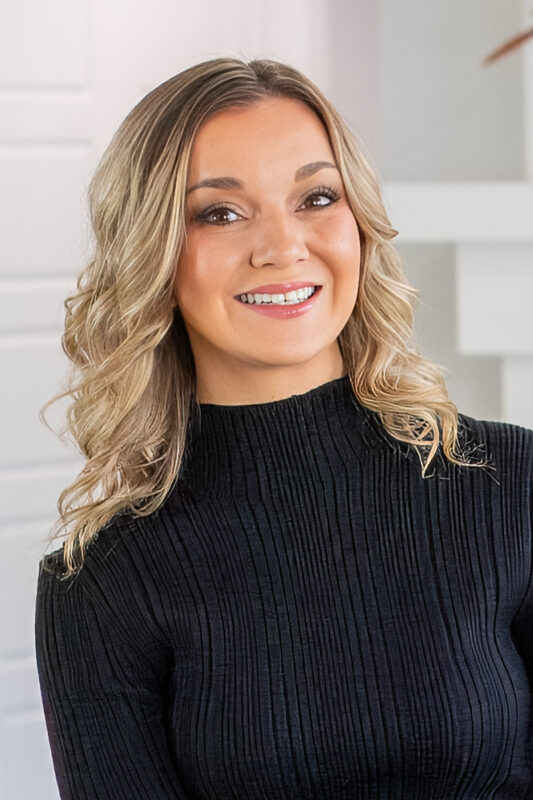 Alex Goedhart, listing agent at CBH Homes, smiling and wearing a black shirt