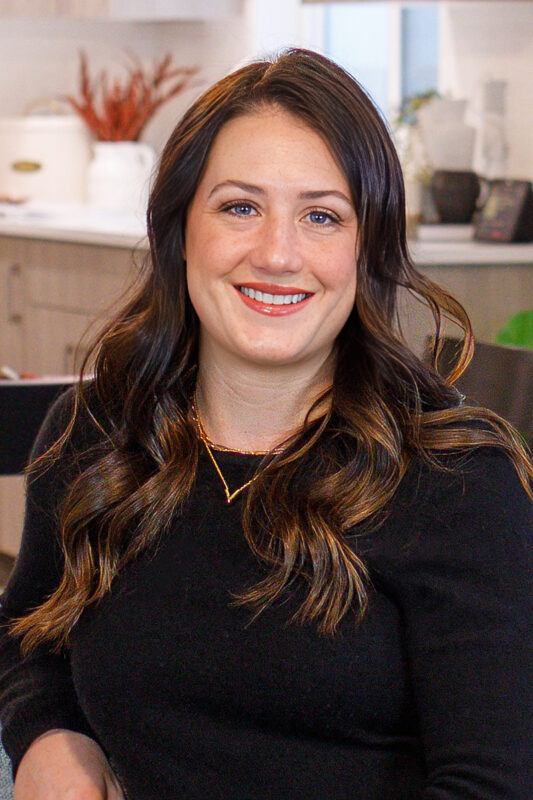 Alexis Roemer, listing agent at CBH Homes, smiling and wearing a black shirt