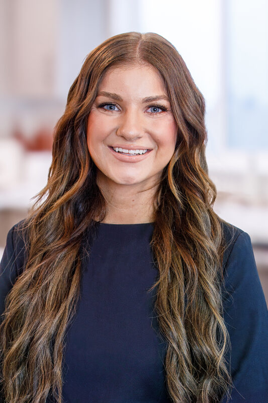 Macy Campbell, listing agent at CBH Homes, smiling and wearing a black shirt