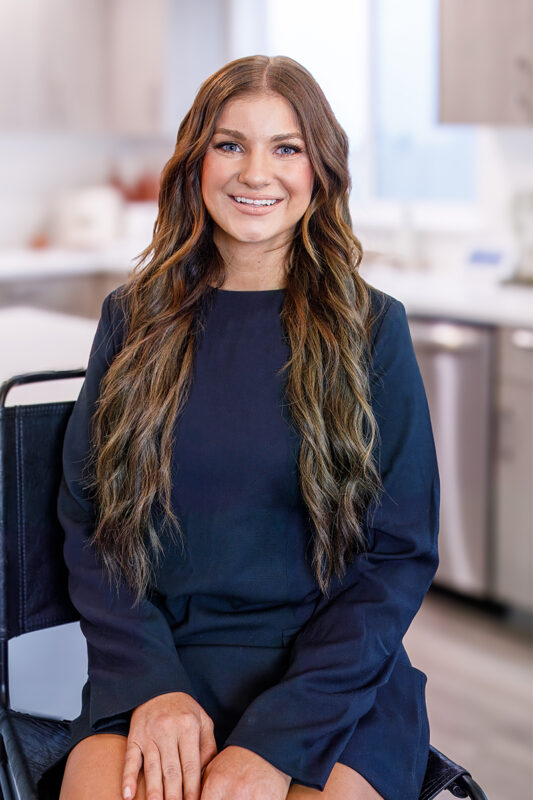 Macy Campbell, listing agent at CBH Homes, smiling and wearing a black shirt