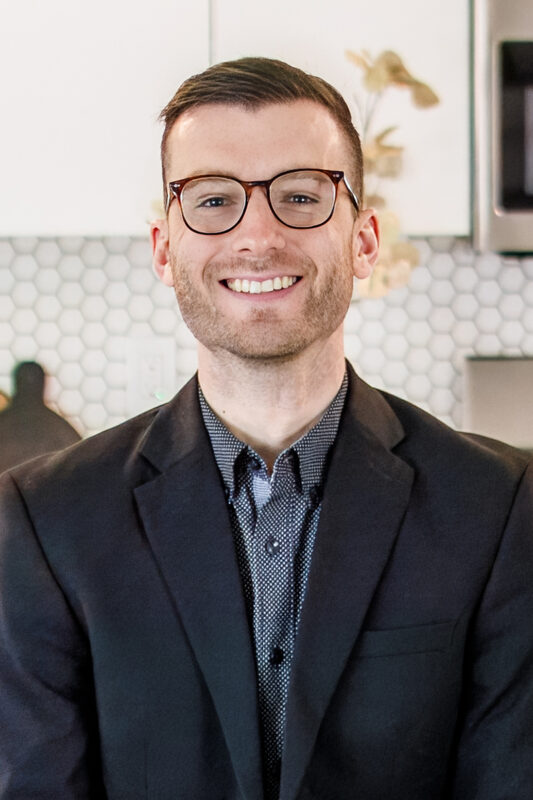 Nick Hafner, listing agent at CBH Homes, smiling and wearing a black shirt