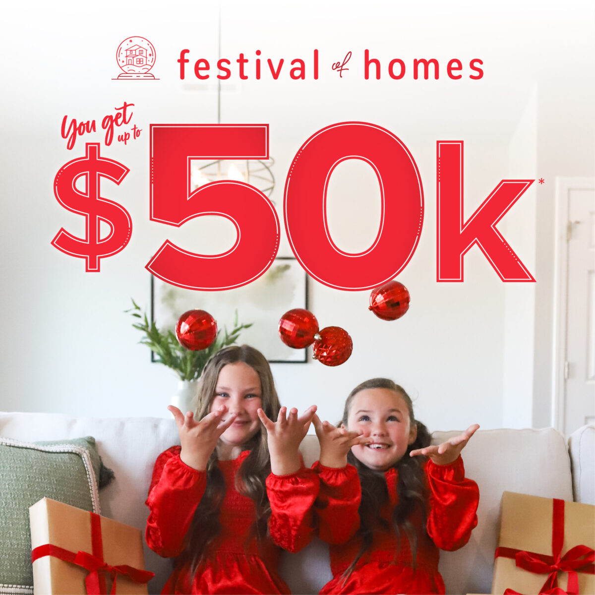 Two girls tossing ornaments in the air on a festive couch