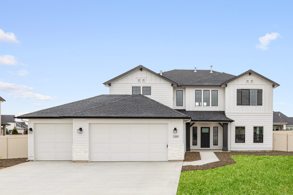 New two-story home with three-car garage and white exterior in Beaconwood, a CBH Homes community in Eagle, Idaho