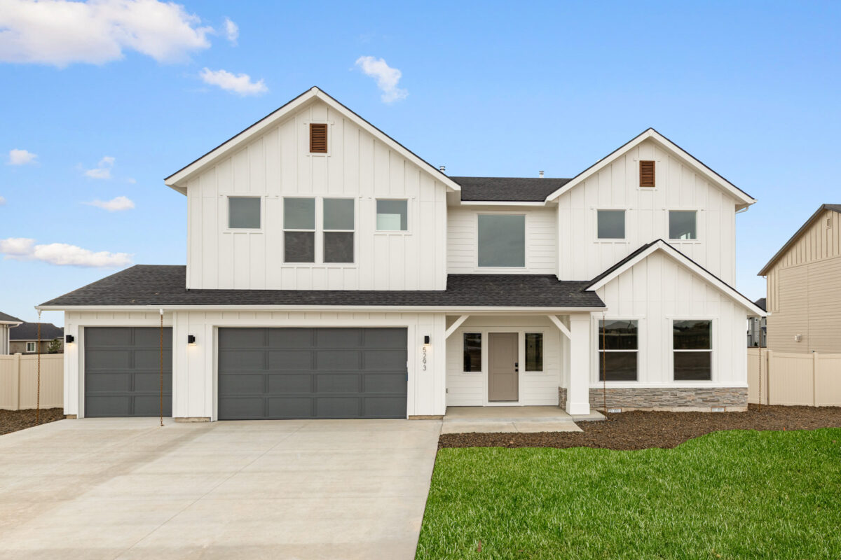 New two-story home with white exterior and three-car garage in Beaconwood, a CBH Homes community in Eagle, Idaho