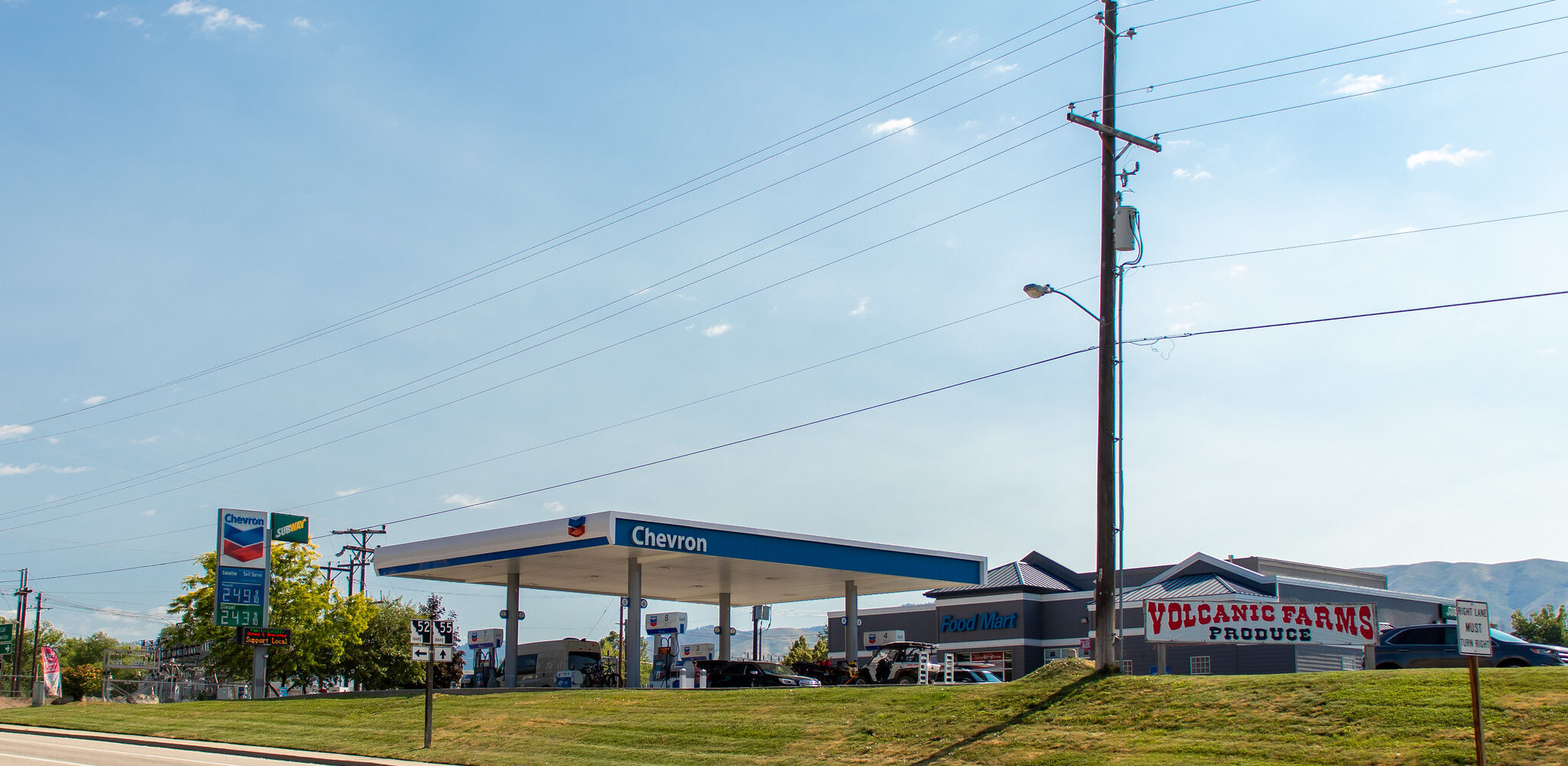 Valley View Chevron gas station and Volcanic Farms Produce stand on Highway 55 in Horseshoe Bend, Idaho, featuring clear skies and community landmarks