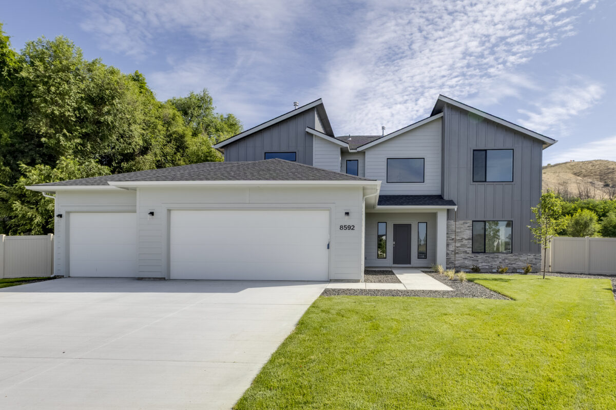 Modern two-story gray home with three-car garage and landscaped front yard at 8592 N Ferris Ave, Boise, Idaho – CBH Homes Milano model