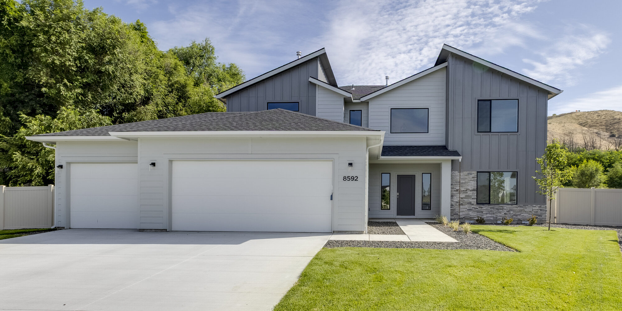 Modern two-story gray home with three-car garage and landscaped front yard at 8592 N Ferris Ave, Boise, Idaho – CBH Homes Milano model