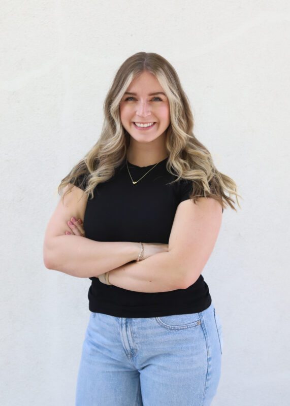 Smiling lady in black top and jeans