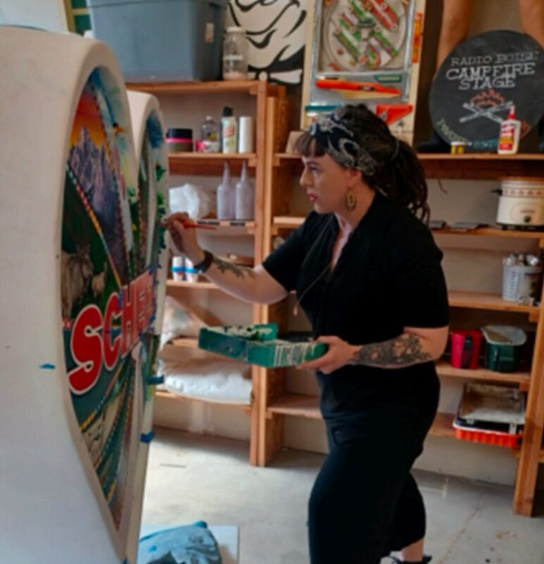 Artist Amber Sheldon painting her heart for hearts across the valley