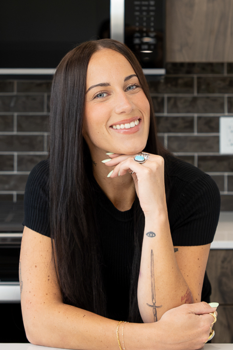 Professional headshot of Annie Allen, CBH Homes sales professional, smiling inside a beautifully designed model home.