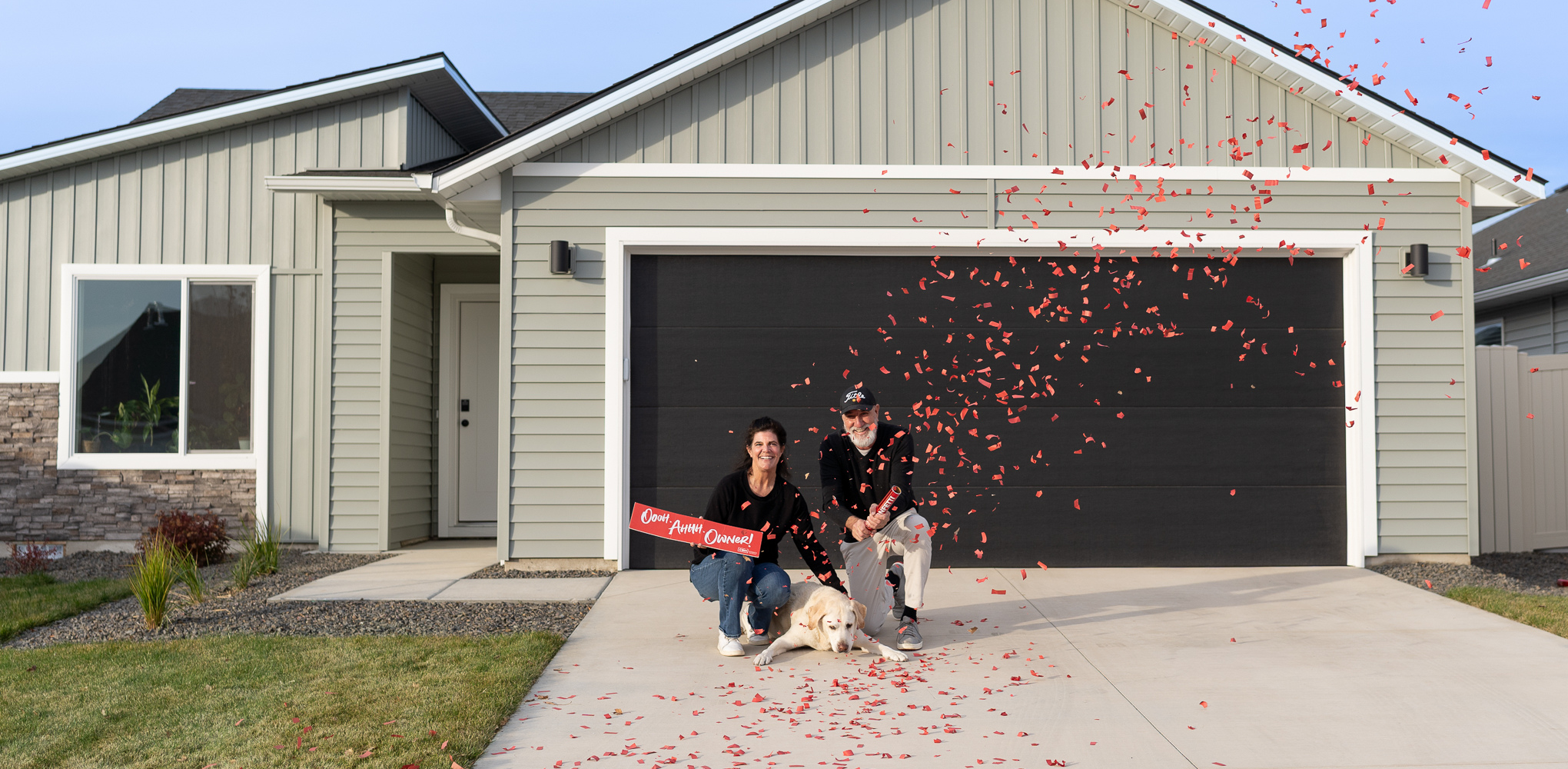 CBH Homes homeowners celebrating in front of their new house with confetti and a sold sign