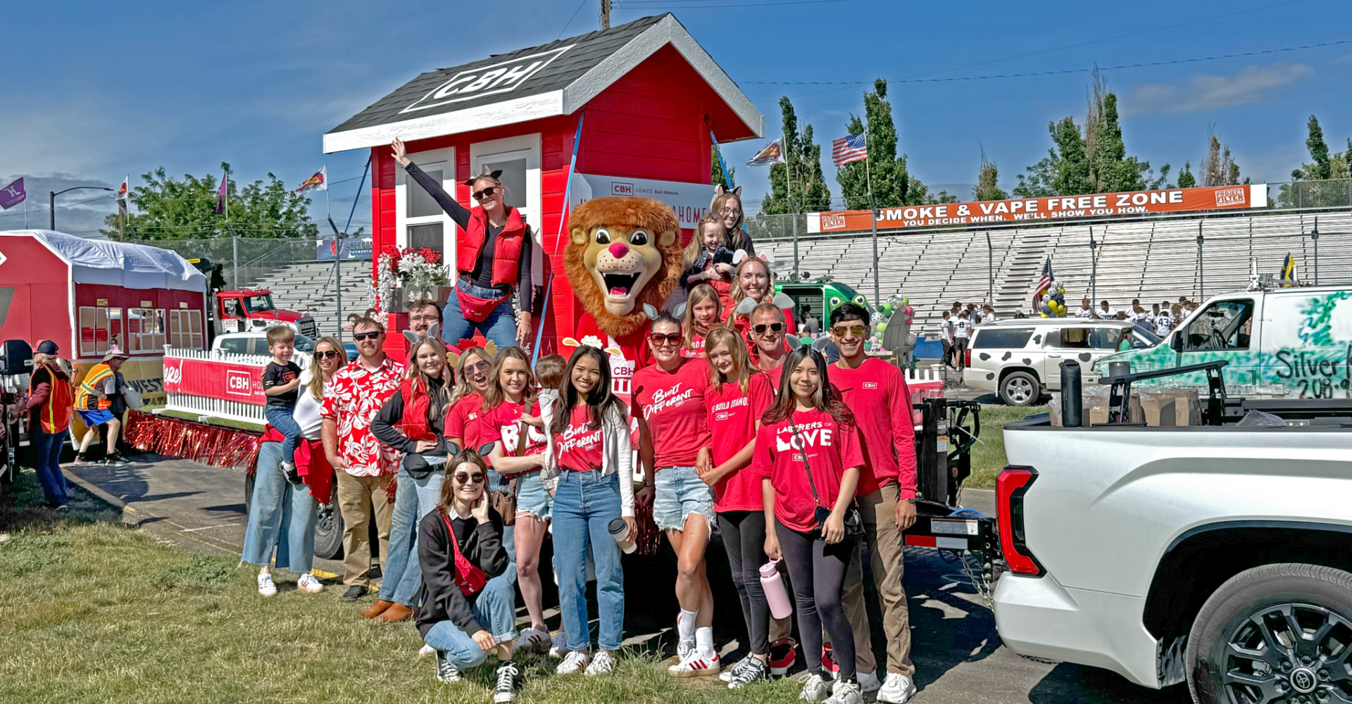 CBH Homes team and parade float at Dairy Days Meridian Idaho with Built Different shirts and lion mascot