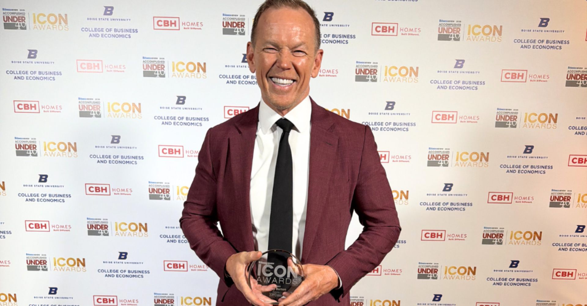 Corey Barton, Owner, Founder, and President of CBH Homes, holds his 2026 Idaho Business Review ICON Award trophy at the awards ceremony in Boise, Idaho.