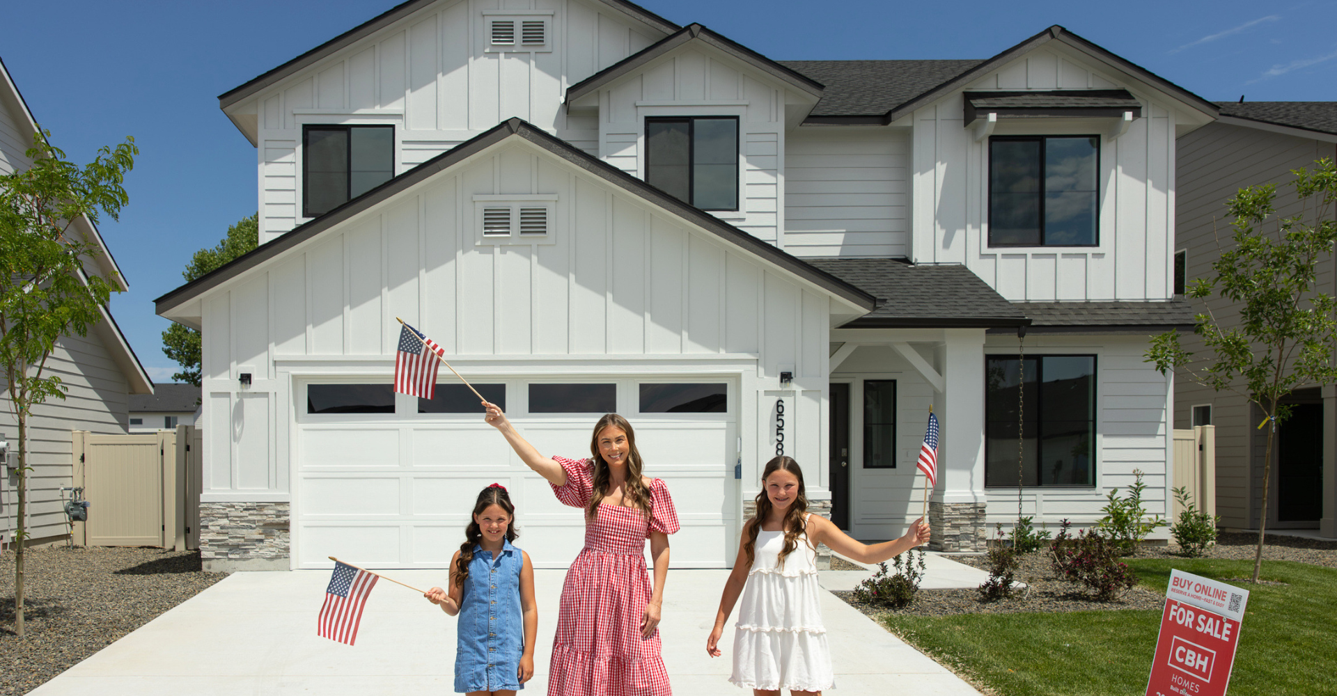 Family waving American flags outside a new CBH Homes property, part of CBH's Fourth of July home sale event.